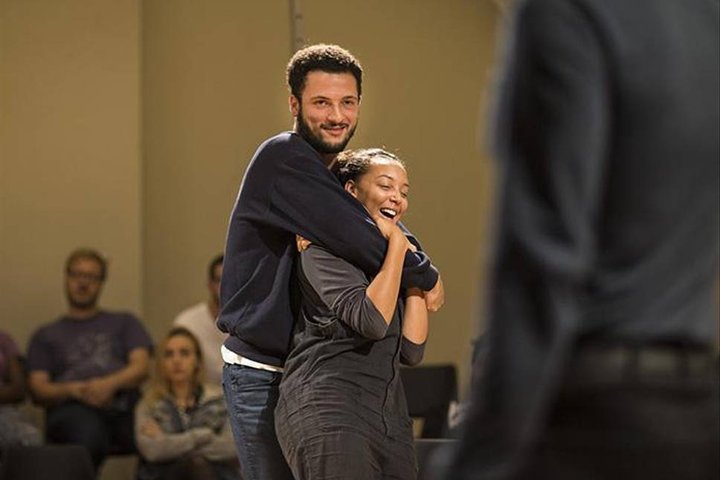 Jamael Westman hugs a cast member in a scene from Torn at the Royal Court Theatre