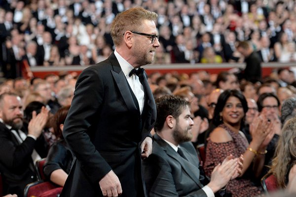 Kenneth Branagh walks past applauding audience to collect his Olivier Award