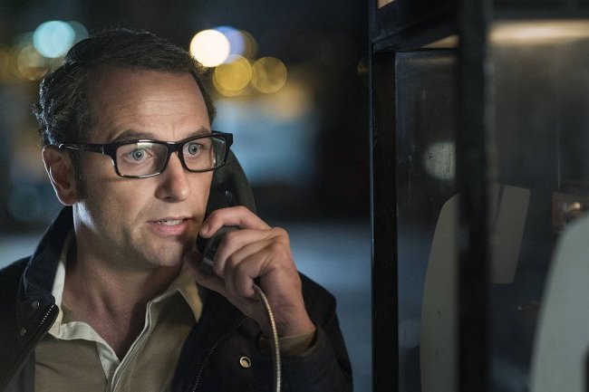 Matthew Rhys speaks on a payphone in a scene from The Americans