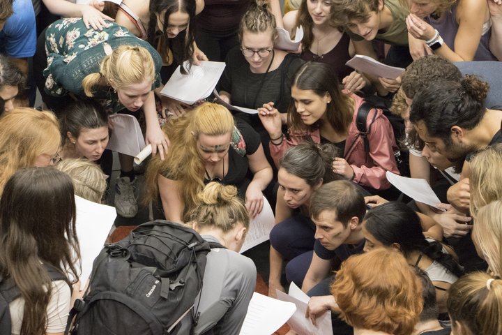 A Shakespearean crowd scene with lots of actors in casual, modern-day dress
